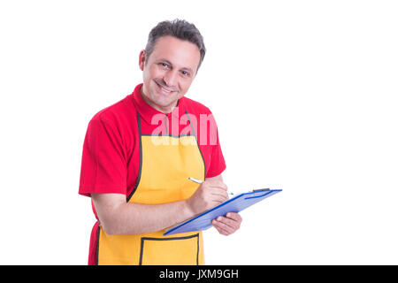 Male staff writing the missing products on clipboard in supermarket Stock Photo