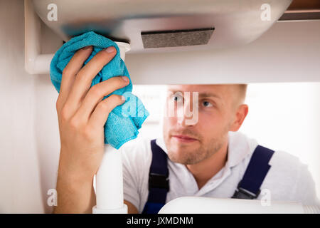 Close-up Of Young Man Repairing Ink In Kitchen Stock Photo