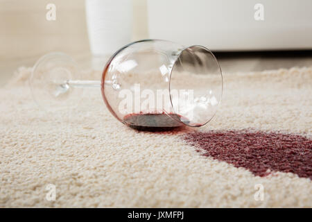 High Angle View Of Red Wine Spilled From Glass On Carpet Stock Photo