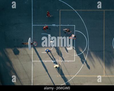 Overhead view of friends on basketball court playing basketball game Stock Photo