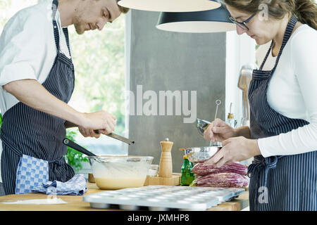 Two chefs working at table, preparing food Stock Photo