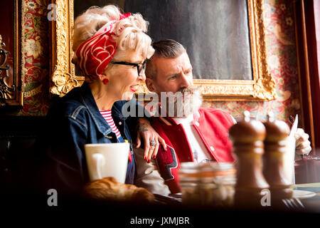 Quirky couple relaxing in bar and restaurant, Bournemouth, England Stock Photo