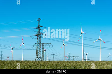 Wind energy and power transmission lines seen in rural Germany Stock Photo