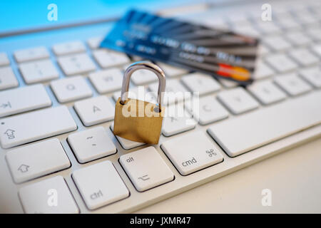 Lock and credit card on computer Stock Photo