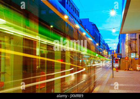 Helsinki, Finland. Tram Departs From A Stop On Street Aleksanterinkatu In Helsinki. Night View Of Aleksanterinkatu Street In Kluuvi District In Evenin Stock Photo