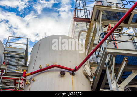 Low angle view of storage tanks and industrial piping at biofuel plant Stock Photo