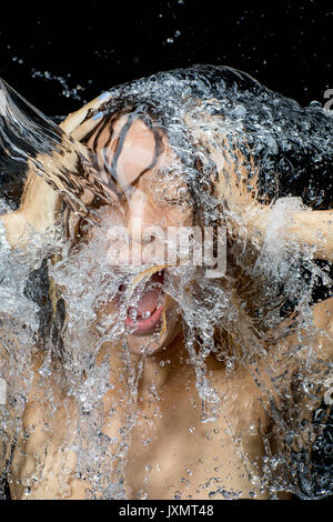 Woman splashing water on face Stock Photo