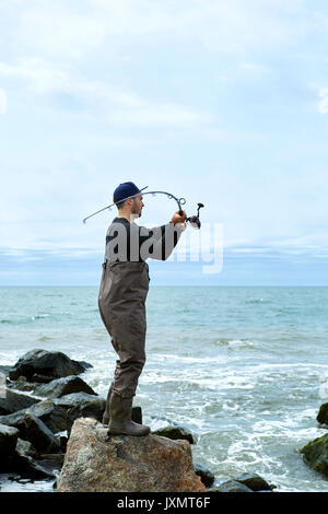 Young Man At Lake Casting Fishing Rod Stock Photo - Download Image Now -  Adult, Casting, Copy Space - iStock