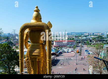 Kuala Lumpur, Malaysia - February 16, 2017 :View of city surroundings from the top of Batu caves stair. In foreground, the world's tallest statue of M Stock Photo