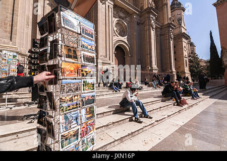 Granada, Spain - 16 february 2013: Main facade of Cathedral and people sitting on steps in Pasiegas Square, Granada, ANdalusia, Spain Stock Photo