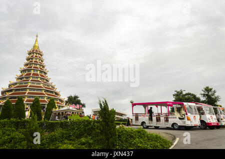 Wat Huai Pla Kung, Shuttle buses in parking lot by huge Chinese style pagoda, Chiang Rai, Thailand Stock Photo