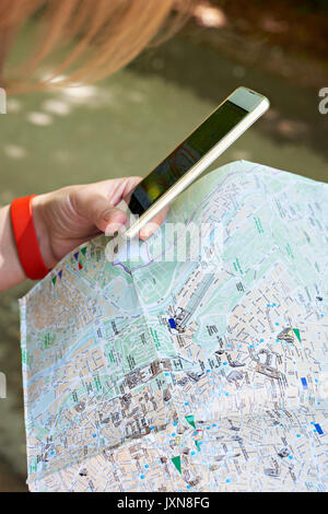 Smartphone with GPS navigator and map in the hands of a tourist Stock Photo