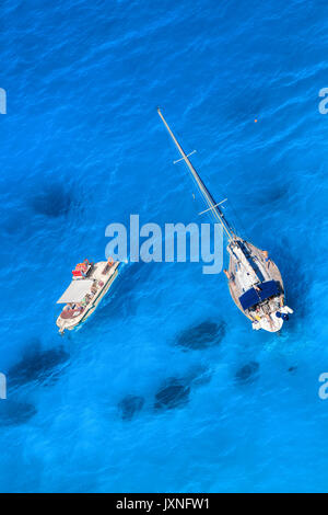 White luxury yacht against azure sea with motor boat Stock Photo