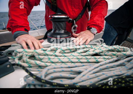 Hands sailor braid rigging ropes on a yacht Stock Photo