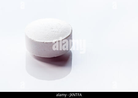 Close Up Of Single Pill On White Background Stock Photo