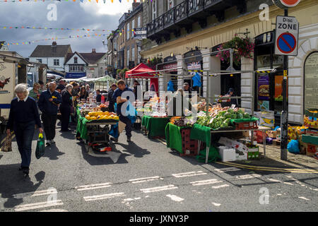 Regular weekly market in Knaresborough North Yorkshire busy crowd and fruit and vegetables on display. Stock Photo