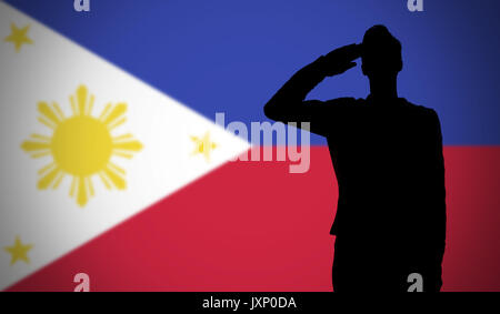 Silhouette of a soldier saluting against the philippines flag Stock Photo