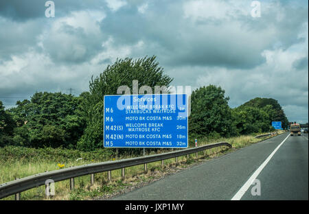 Signpost for services at various places, taken from the M6 motorway near Birmingham, heading west, England, UK. Stock Photo