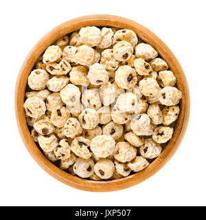 Tiger nuts in wooden bowl. Blanched and dried tubers of Cyperus esculentus. Earth almond, chufa sedge, nut grass or yellow nutsedge. Macro food photo. Stock Photo