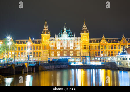Amsterdam, Netherlands - April 20, 2017: City scenic from Amsterdam in the Netherlands by night with the central station Stock Photo