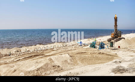 Dubai, United Arab Emirates - May 03, 2017: Workers at a beach construction site between Dubai and Sharjah. Stock Photo