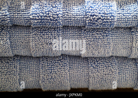 Closed up Texture of Neatly Folded Pale Blue Fluffy Bath Towels Stack, for Background Stock Photo