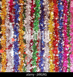 Colorful shiny decorations hanging on a wall Stock Photo