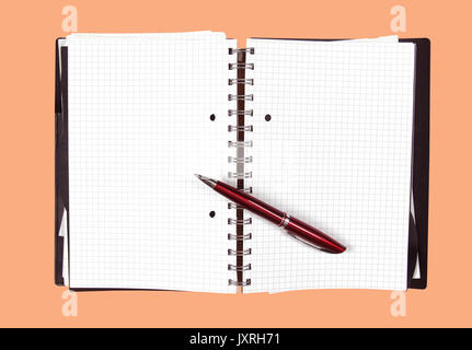Open notebook with blank pages and pen inside Stock Photo