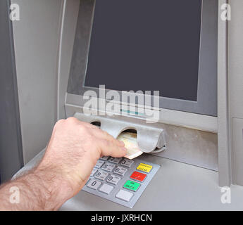 Male hand taking Euro banknotes from bank machine Stock Photo
