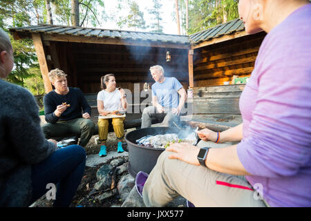 Business People Talking While Having Lunch In Forest Stock Photo