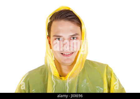 Picture of a caucasian young man wearing a yellow raincoat, posing on isolated background Stock Photo