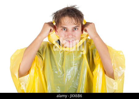 Picture of a caucasian young man wearing a yellow raincoat, posing on isolated background Stock Photo