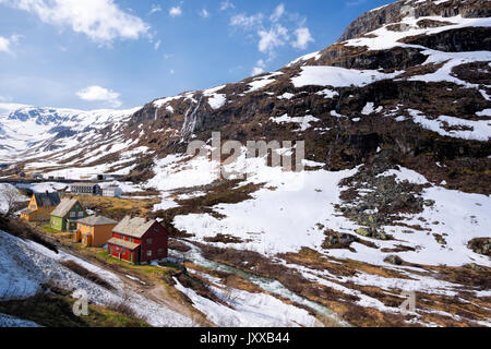 Norway with colorful wooden houses against waterfalls during spring time. Railroad from Flam to Myrdal in Norway Stock Photo