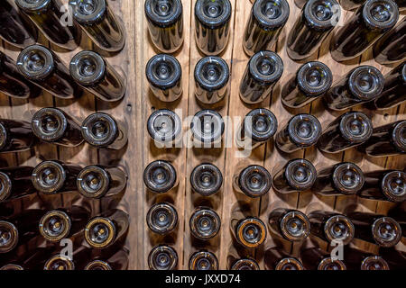 Bottoms of wine bottles stacked in cellar
