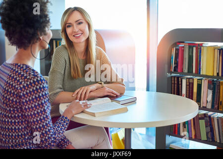 Friends talking about favorite books Stock Photo