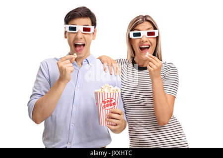 Young man and woman wearing 3D glasses and eating popcorn isolated on white background Stock Photo