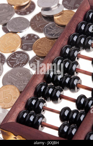 Close up of an old wooden Chinese Abacus and Chinese coins Stock Photo