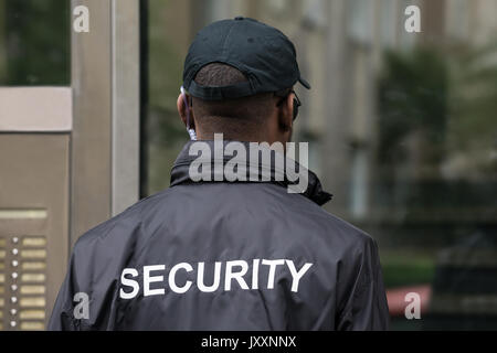 Rear View Of A Male Security Guard Wearing Black Uniform Stock Photo