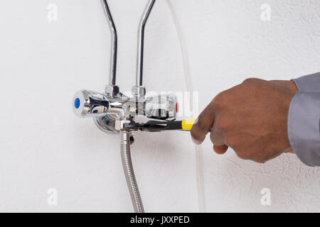 Close-up Of Male Worker's Hand Repairing Electric Boiler Stock Photo