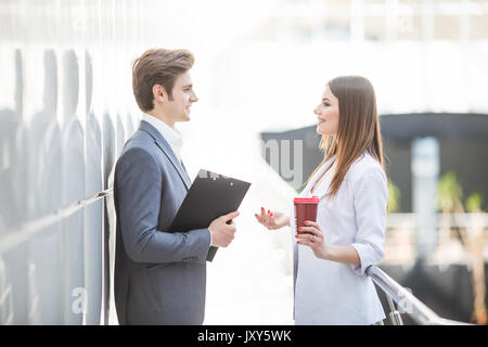 Two Business Colleagues Sitting Around Boardroom Table Having Informal Discussion Stock Photo