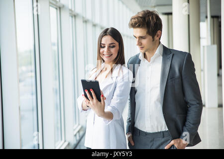 Cheerful photo editors working together on tablet pc in office Stock Photo