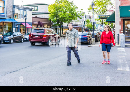 Bar Harbor, USA - June 8, 2017: People crossing sidewalk street in downtown village in summer on main road Stock Photo