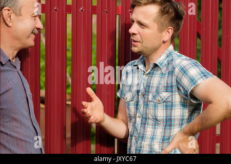 Retired elderly people and friendship, two old men meeting and talking in city park Stock Photo