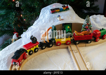 wooden train set around christmas tree