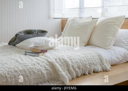 sylish bedroom interior design with black and white pillows on bed. Stock Photo