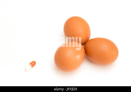 egg and pill isolated on white background Stock Photo