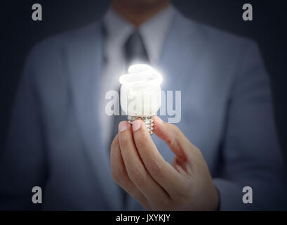 businessman holding light bulb Stock Photo