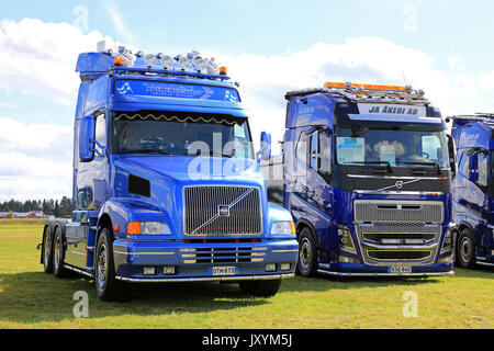 ALAHARMA, FINLAND - AUGUST 11, 2017: Blue conventional Volvo NH12 of Thoden Oy and cab over FH750 of JA Akeri AB trucks on display on Power Truck Show Stock Photo