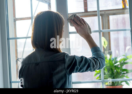 Woman cleaning window with rag Stock Photo