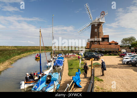 Boats on the River Glaven next to the windmill in Cley Next The Sea Norfolk Stock Photo